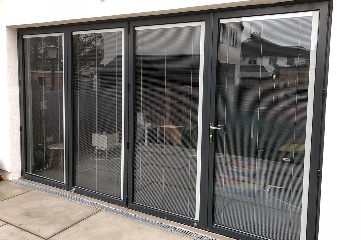 outside view Visofold 1000 bifold doors with integrated blinds