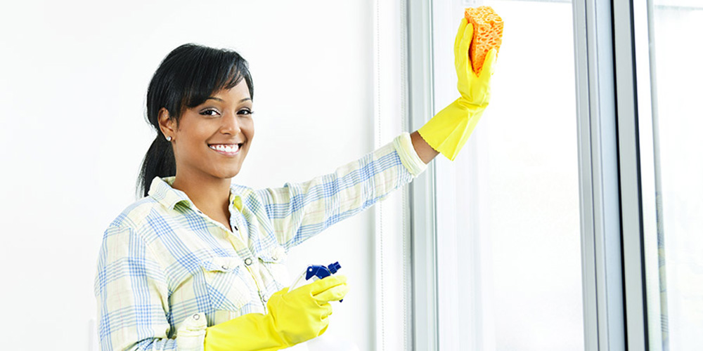 woman cleaning bi fold doors